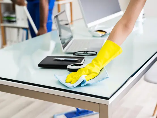 person cleaning desk